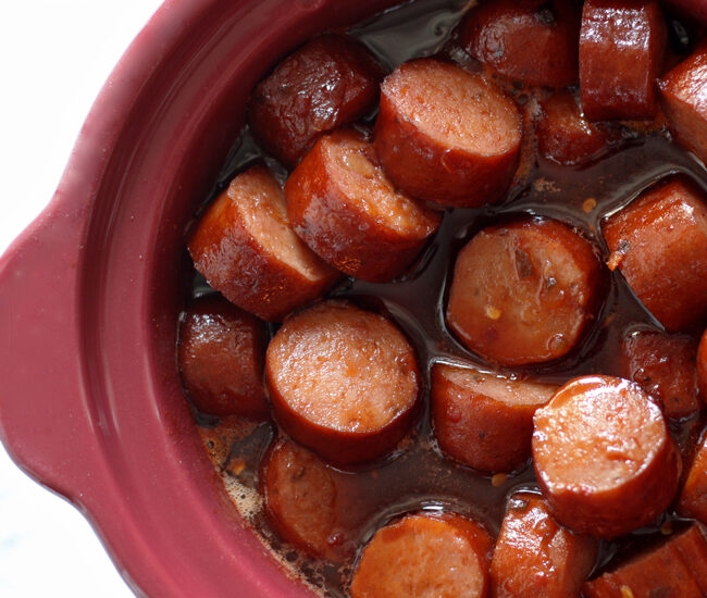 Our Slow Cooker Sweet Spicy Sausage is the perfect blend of sweet, spicy and smoky and is sure to be your new favorite appetizer!