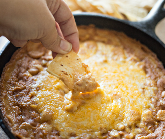Whip up this easy and delicious Green Chile Bean Dip in one skillet and serve!