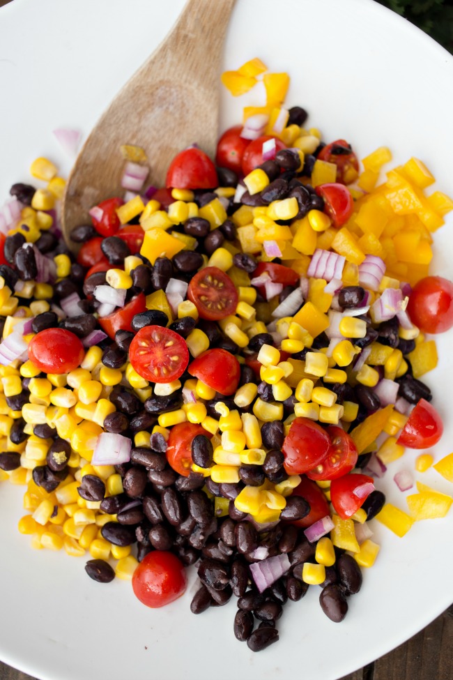 All the flavors of the Southwest in one zesty Black Bean Salsa Salad! Perfect for summer parties, this simple salad will be a hit!
