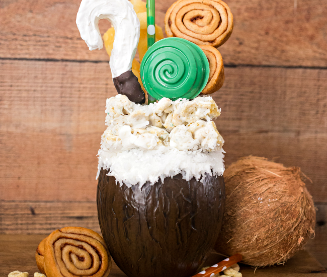 If you like Pina Coladas...you'll love this Disney inspired Moana Pina Colada Freak Shake! A delicious tropical shake topped with Moana inspired treats.