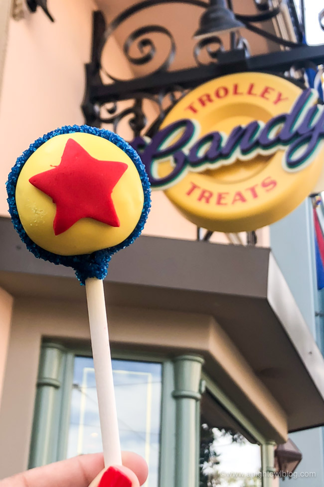 Pixar Cake Pop from Trolley Treats, Disney California Adventure Park, Buena Vista Street | From Cheeseburger Pizza from Alien Pizza Planet to the Toy Story Root Beer Float in a Souvenir Boot, check out our picks for The BEST Disneyland Pixar Fest Food finds! #Disneyland #PixarFest