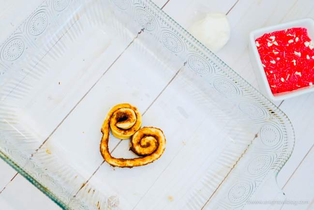 Perfect for Valentine's Day Breakfast, whip up these easy and adorable Heart Shaped Cinnamon Rolls made with store bought cinnamon rolls!