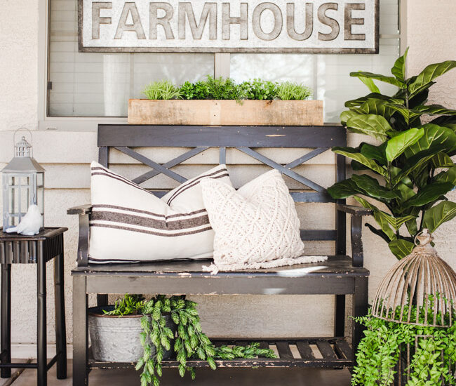 This year, create an easy Spring Farmhouse Porch with lifelike greenery, farmhouse signs and plenty of rustic elements and charm.