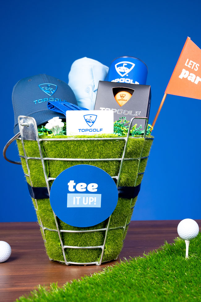 Perfect for the golf lover in your life, whip up a “Tee It Up” Golf Gift Basket with Evite And Topgolf!